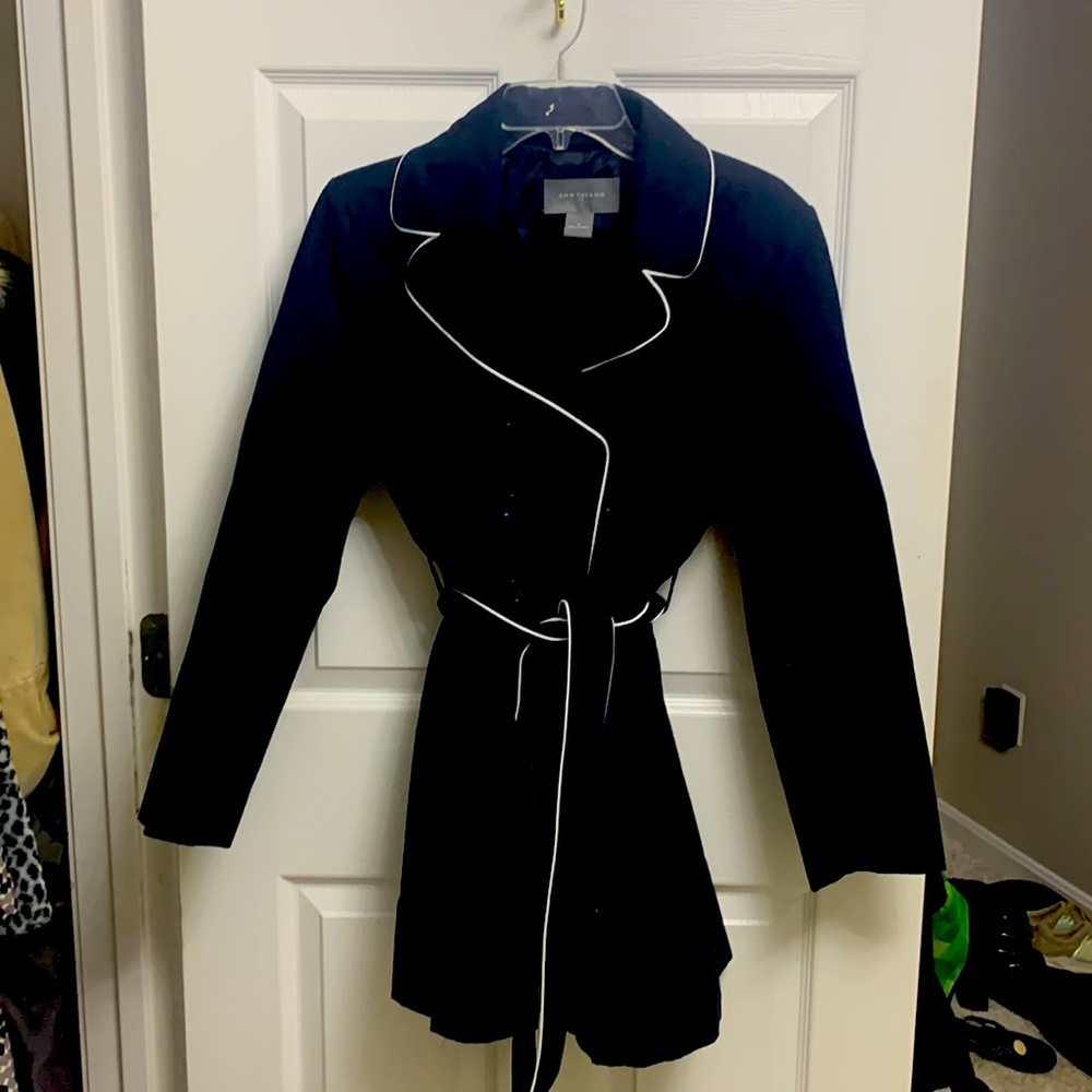 Navy blue double breasted trench coat with white trim